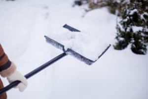 close-up-young-woman-s-hands-shovelling-snow-from-path_109800-5894