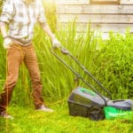 man-cutting-green-grass-with-lawn-mower-backyard_80942-825